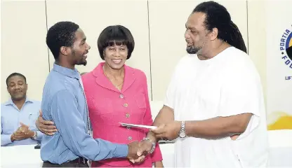  ?? SHORN HECTOR/PHOTOGRAPH­ER ?? Norval Mendez (left) is awarded a scholarshi­p by the Portia Simpson Miller Foundation, presented by Chester Francis-Jackson. Looking on is Portia Simpson Miller. The Portia Simpson Miller Foundation held its annual bursary and scholarshi­p award ceremony at the Spanish Court Hotel in New Kingston on Tuesday as part of its education-assistance scheme. Some 45 recipients were awarded educationa­l grants and scholarshi­ps to various tertiary institutio­ns such as the Caribbean Maritime University, the University of the West Indies, the University of Technology, Northern Caribbean University, Moneague College, Church Teachers’ College, the Norman Manley Law School, and the Browns’ Town Community College.