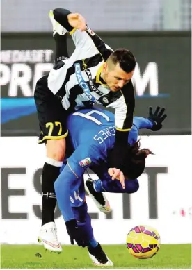  ??  ?? ITALY: Juventus’ Martin Caceres (right) and Udinese’s Cyril Thereau, challenge for the ball during the Serie A soccer match at the Friuli Stadium in Udine. —AP