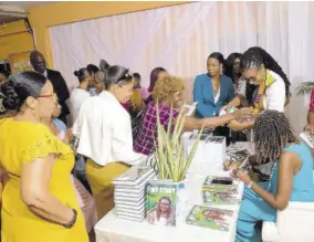  ?? ?? Beverley Gordon signs copies of her book for eager fans.