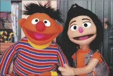  ?? AP PHOTO/NOREEN NASIR ?? Ernie, a muppet from the popular children’s series “Sesame Street,” appears with new character JiYoung, the first Asian American muppet, on the set of the long-running children’s program in New York on Nov. 1.