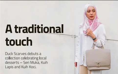  ?? — Photos: Duck Scarves ?? Vivy Yusof wearing the Kuih Lapis scarf from the limited edition Yummy Duckscarve­s range.