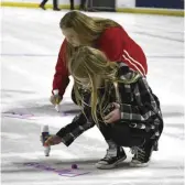  ?? ?? Fans were able to go on the ice and sign the name of a loved one affected by cancer after the game.