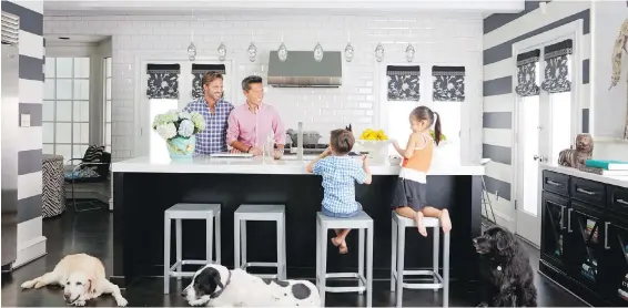  ??  ?? HGTV star Vern Yip and his family hang out in their stylish kitchen. Families with pets have several options for durable, attractive flooring, including wood with finishes that resist scratching from claws and waterproof ceramic tile designed to look...