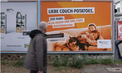  ?? Photograph: Sean Gallup/Getty ?? A government poster in Berlin reads: ‘Dear Couch Potatoes, just do it: heat smartly and dial down a notch.’