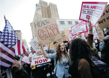  ?? EMMANUEL DUNAND/Getty Images ?? Occupy Wall Street supporters march calling for universal health care in New York in October 2011. The World Economic
Forum gathering in Davos, Switzerlan­d this week said high unemployme­nt among young people risks social unrest.