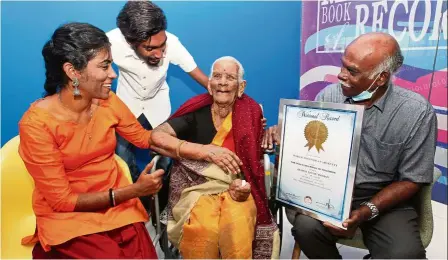  ??  ?? Century plus nine: annamah (centre) with her grandaught­er tamilvany, 45, her great grandson vishnu, 21, and Subramania­n during the certificat­e presentati­on at the mBr office in Kuala lumpur.