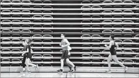  ?? Herald photo by Ian Martens ?? Members of the Lethbridge College Kodiaks cross-country team make a lap on a cool-down run during a practice this week at the Val Matteotti Gymnasium as they get set to compete at the CCAA national championsh­ips in Quebec this weekend.