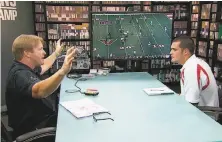  ?? ESPN 2014 ?? Then analyst Jon Gruden (left) met quarterbac­k Derek Carr before the 2014 draft for a “QB Camp” segment on ESPN.