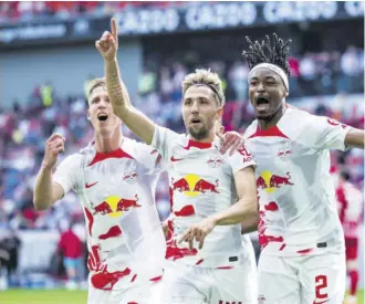  ?? ?? Leipzig’s Kevin Kampl (centre), celebrates with Leipzig’s Daniel Olmo Carvajal (left), and Leipzig’s Mohamed Simakan after scoring the opening goal during a German Bundesliga soccer match between SC Freiburg and RB Leipzig in Freiburg, Germany, Saturday, May 6, 2023.