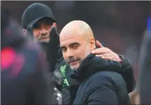  ?? AP ?? Liverpool manager Jurgen Klopp shares a light moment with Manchester City boss Pep Guardiola during Sunday’s English Premier League match at Anfield.