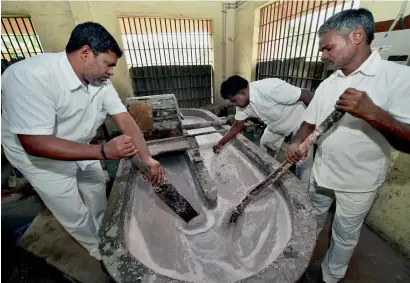  ?? PTI ?? Inmates work on demonetise­d notes, supplied by Reserve Bank of India, for making file pads at Puzhal Central Prison in Chennai. —