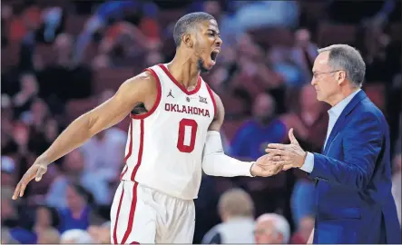  ??  ?? [SARAH PHIPPS/THE OKLAHOMAN] OU's Christian James celebrates a 3-point basket with coach Lon Kruger during a victory over Kansas last week.