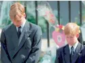  ??  ?? Prince William (L) and Prince Harry bow their heads during the funeral service for Diana on September 6, 1997