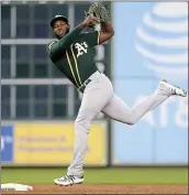  ?? MICHAEL WYKE — THE ASSOCIATED PRESS ?? A’s second baseman Jurickson Profar turns a double play against the Astros during the third inning of Thursday night’s game at Houston’s Minute Maid Park.