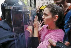  ??  ?? Violence: Police push voters in Barcelona on October 1