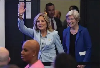  ?? CHARLES KRUPA, POOL — THE ASSOCIATED PRESS ?? First lady Jill Biden, left, waves to guest while introduced with Sen. Elizabeth Warren, D-Mass., during a discussion on women’s health research Wednesday in Cambridge, Mass.