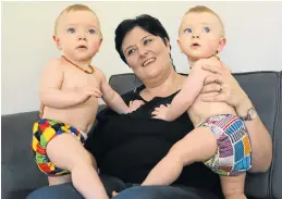  ?? Picture: RUVAN BOSHOFF ?? BOTTOM LINE: Anti-disposable advocate Angeliquec­a Roux with her twins William, left, and Robert, sporting their cloth nappies