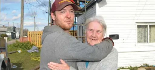  ??  ?? Jeremy Locke, owner of Locke's Roofing and Constructi­on in Bridgeport, shares an emotional moment with Jeanette MacDonald of Glace Bay. Sharon Montgomery-Dupe