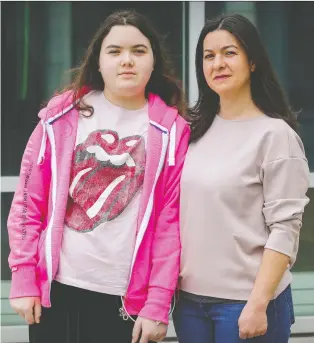  ?? JOHN MAHONEY ?? Rebecca Marchand, with her mother, Stephanie Peillon, was hospitaliz­ed for weeks with what doctors say could have been multisyste­m inflammato­ry syndrome in children, a rare, POST-COVID-19 ailment.