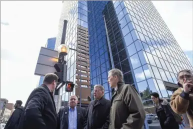  ??  ?? Paul Johnson, Hamilton’s LRT project director, left, Waterloo Region Coun. Tom Galloway, Waterloo regional chair Ken Seiling and Hamilton Mayor Fred Eisenberge­r talk light rail at MacNab and King streets Tuesday. They were visiting businesses along the...