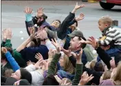  ?? SHAUN WALKER — THE TIMES-STANDARD FILE ?? People reach up to grab falling ping pong balls during Eureka Main Street’s 3rd-annual Snowball Drop in 2017.