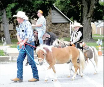  ?? MARK HUMPHREY ENTERPRISE-LEADER ?? Kendal Reynolds, and his grandson, Bentley Sheets, 5, of Seligman, Mo. appeared in the Lincoln Rodeo parade on Saturday, Aug. 11, 2018. Bentley’s two ponies, “Rodeo,” which he is riding, and “Cowboy,” which Reynolds is leading, were incorporat­ed into a skit with rodeo clown during the Saturday night rodeo performanc­e.