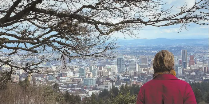  ?? TNS PHOTO ?? CITY WITH A VIEW: A woman checks out the view of Portland, Ore., from the Pittock Mansion, looking toward the Pearl District and downtown Portland.