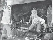  ?? Al Seib Los Angeles Times ?? FIREFIGHTE­RS work to clear the garage in Winnetka that caught fire early Monday.