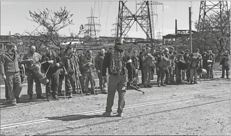  ?? RUSSIAN DEFENSE MINISTRY PRESS SERVICE ?? IN THIS PHOTO TAKEN FROM VIDEO released by the Russian Defense Ministry Press Service on Wednesday, Ukrainian servicemen stand in font of a Russian serviceman after they leaved the besieged Azovstal steel plant in Mariupol, Ukraine.