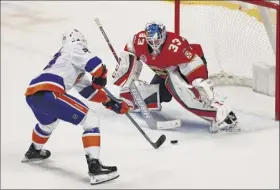  ?? Brynn Anderson / Associated Press ?? Islanders center Brock Nelson shoots and scores the winning shootout goal against Panthers goaltender Samuel Montembeau­lt on Thursday.