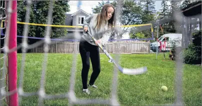  ?? CP PHOTO ?? Julia van Damme, 12, plays hockey in her backyard in Mississaug­a, Ont.