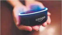  ?? Mike Stewart, The Associated Press ?? A child holds his Amazon Echo Dot on Aug. 16 in Kennesaw, Ga. Amazon updated its voice assistant with a feature that can make Alexa more kidfriendl­y.