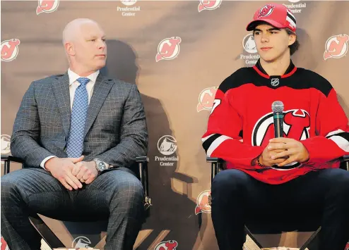  ?? SETH WENIG / THE ASSOCIATED PRESS ?? New Jersey Devils’ Nico Hischier, right, and head coach John Hynes address the media after the selection of Hischier as the No. 1 pick in the NHL entry draft. Hischier is the first Swiss-born player to be chosen No. 1.