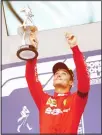  ??  ?? Ferrari driver Charles Leclerc of Monaco lifts the trophy after finishing first in the Belgian Formula One Grand Prix in Spa-Francorcha­mps,
Belgium on Sept 1. (AP)