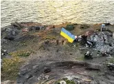  ?? ?? VICTORY Flag raised as Ukraine retakes island