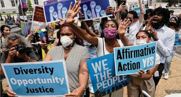  ?? Kenny Holston/New York Times ?? Demonstrat­ors gather outside the Supreme Court on Thursday to protest the ruling curtailing affirmativ­e action at colleges and universiti­es around the nation.