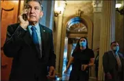  ?? KENT NISHIMURA/LA TIMES ?? Sen. Joe Manchin, D-W.Va., has said he cannot explain the bill to constituen­ts. But a union representi­ng coal miners, including nearly 12,000 from his home state, urged the lawmaker to “revisit his opposition.”