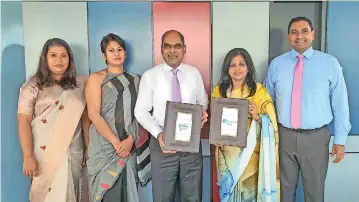  ??  ?? Ms. Premila Paulraj - Director, Employabil­ity and Qualificat­ions - Pearson South Asia exchanging the agreement with Dr Harsha Alles, Chairman Gateway Group. Also in the picture; L-R Ms. Hasini Gajadeera, Head - School of Education and Teacher Training, Gateway Graduate School; Ms. Thusitha Illukpitiy­a, Chief Operating Officer, Gateway Group; Mr. Suriya Bibile, Country Head, Pearson Sri Lanka.