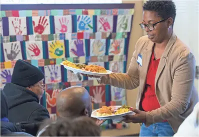  ?? PHOTOS BY MARK HOFFMAN / MILWAUKEE JOURNAL SENTINEL ?? Volunteer Esther Montgomery serves dinner to clients Sunday at Repairers of the Breach, 1335 W. Vliet St., Milwaukee.