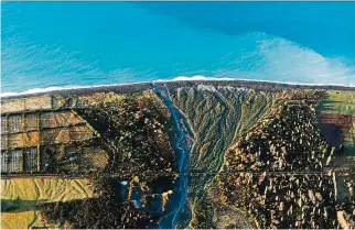  ??  ?? Entitled The River Of Life, this image shows the Hapuku River, the blue line flowing into the ocean; the horizontal line cutting across it are train tracks on a bridge. The photo’s title was inspired by the area’s amazing variety of wildlife, including...