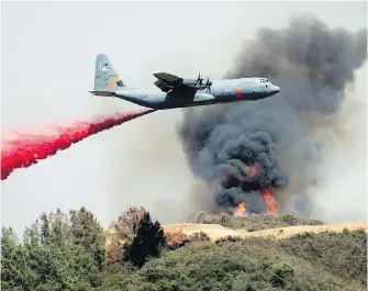  ?? THE ASSOCIATED PRESS ?? An air tanker drops retardant on the River Fire near Lakeport, California, on Tuesday.