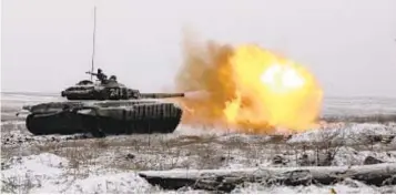  ?? ?? A Russian tank fires as troops take part in drills at firing range in southern Russia on Wednesday. Failure of diplomatic meetings has put Russia, the U.S. and its European allies in uncharted post-Cold War territory.