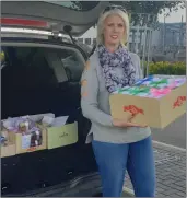  ??  ?? Tanya McCabe loading up her car with treats and right, Elaine is one of the Cake Fairies!