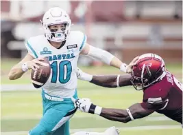  ?? VASHA HUNT/AP ?? Coastal Carolina QB Grayson McCall tries to escape a tackle during Saturday’s victory over Troy. The Chanticlee­rs finished the regular season 11-0.