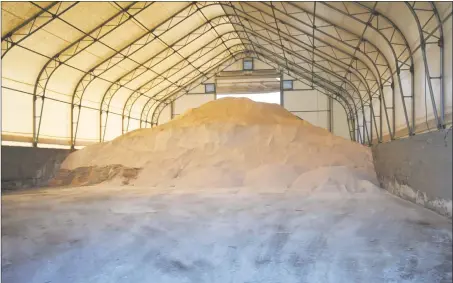  ?? Ben Lambert / Hearst Connecticu­t Media ?? The salt and sand mixture awaits use Tuesday in the Torrington Street Department’s facility as local towns prepared for the coming snowstorm. The National Weather Service forecast about a foot of snow could fall in Torrington and perhaps more in points...