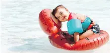  ?? DARREN MAKOWICHUK ?? Olivia Nagy, 2, floats on the water at the Bowness Park wading pool.