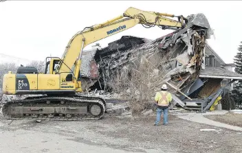  ?? TROY FLEECE ?? Under an order from the City of Regina, an excavation crew knocked down a home that contained a dozen units this week. Its owners said they didn’t receive advance notice the building was being demolished.