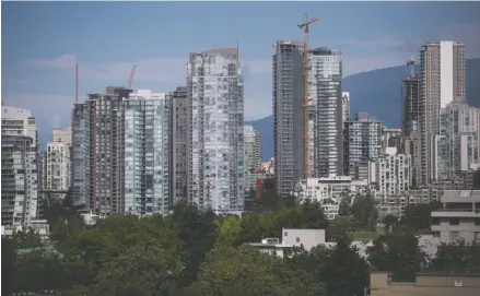  ?? THE CANADIAN PRESS/DARRYL DYCK PHOTO ?? Condo towers are seen in downtown Vancouver in August. The latest property transfer data released by the British Columbia government shows the percentage of sales involving foreign nationals in Metro Vancouver inched up between April and September.