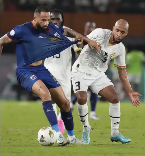  ?? AP ?? Ghana’s Denis Odoi, right, battles for the ball during their surprise loss to Cape Verde