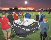  ?? DARRYL WEBB/FOR THE REPUBLIC ?? Members of the Red Fury fan group carry a banner in honor of the El Paso shooting victims on Saturday.